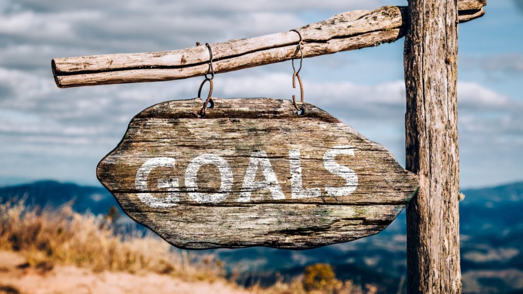 wooden post with word goals across it for 7 Reasons Why People Don't Achieve Their Goals & What You Can Do To Avoid This