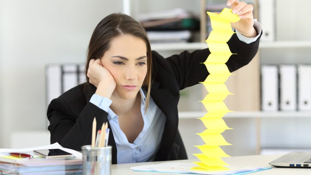 woman bored with her job making paper chain