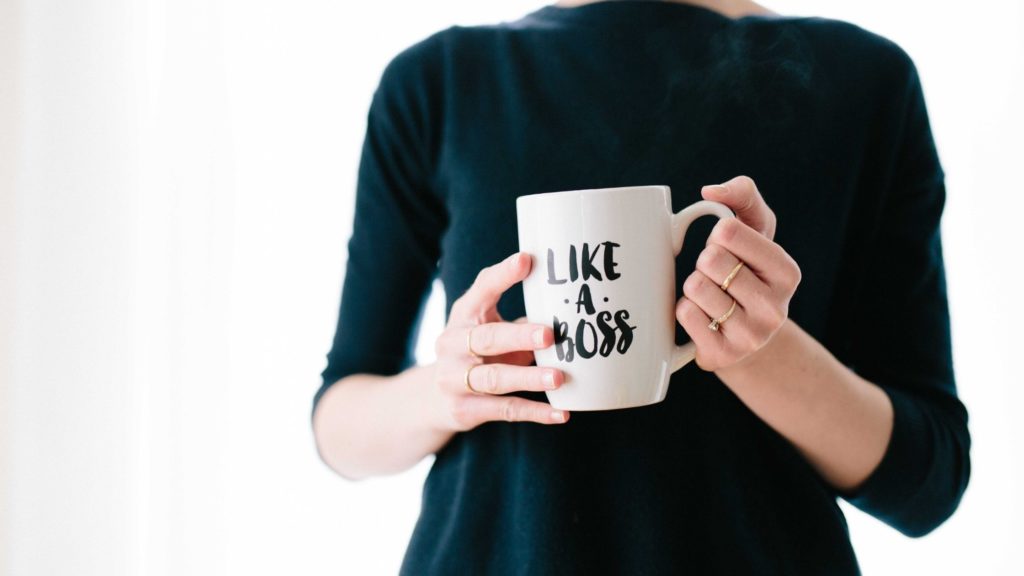 Woman holding mug with words 'Like a Boss' on it