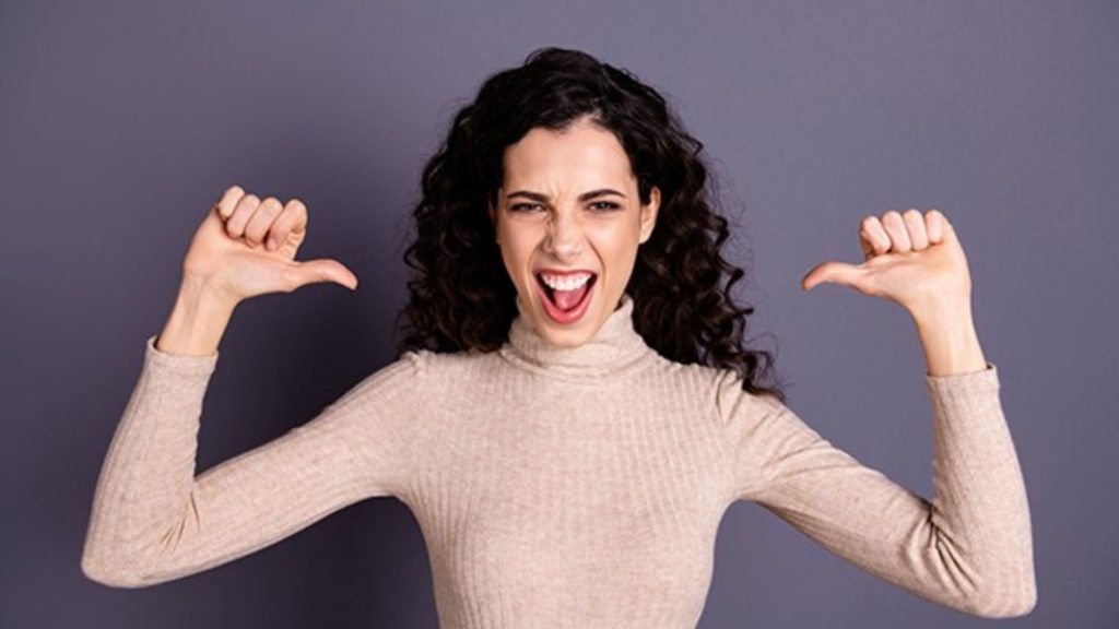 woman with arms up pointing to herself promoting her personal branding
