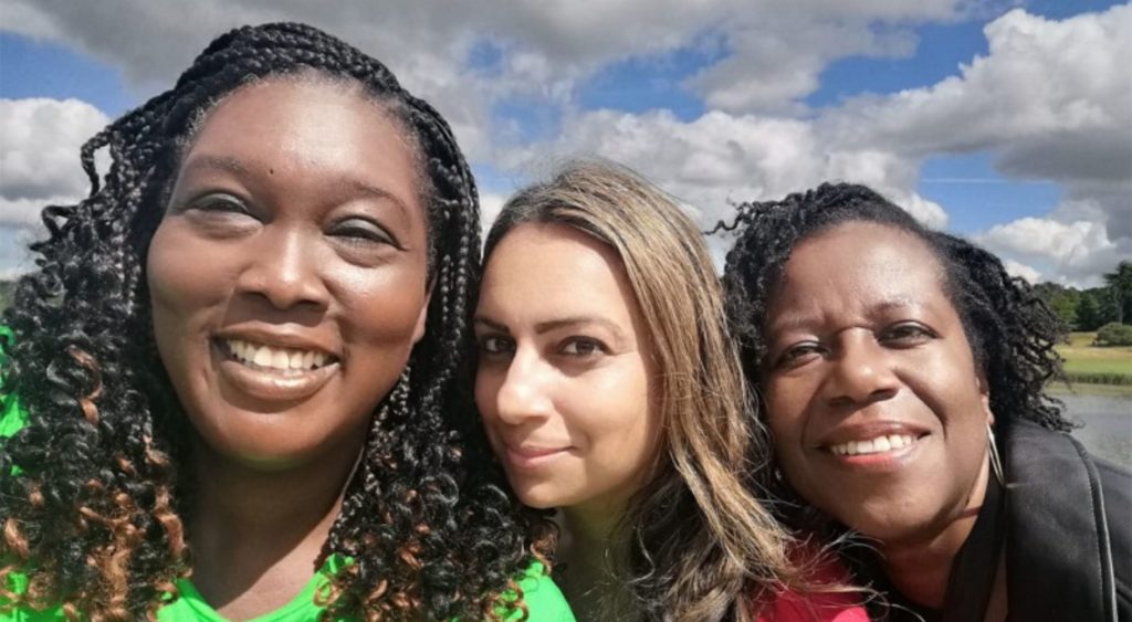group of 3 women out for the day, take a selfie headshot close together with sky in background